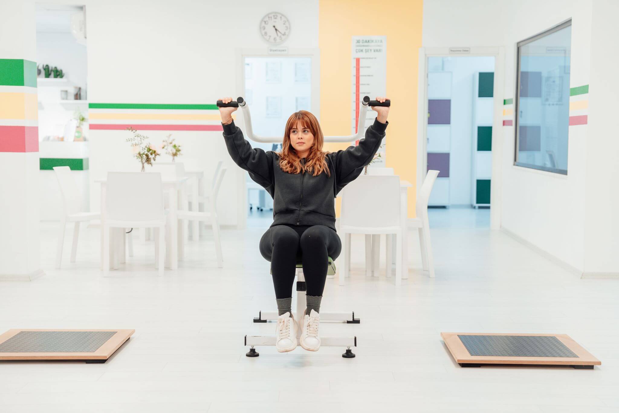 A woman exercising with weights indoors at a fitness facility in Yalova, T&uuml;rkiye.